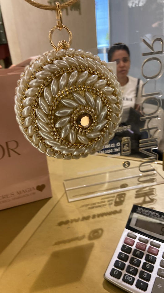Cartera dorada con perlas